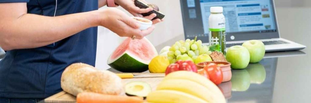 Dietitian cutting an array of fruit 